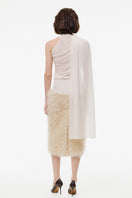 Creamy white plush midi skirt by Kris Marán, shown in a close-up image highlighting soft fabric and elegant design.