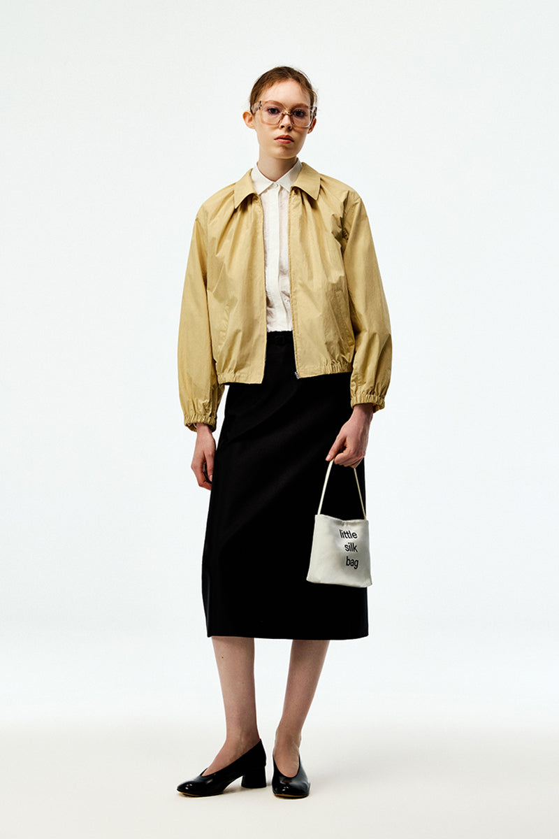 Beige cotton bomber jacket from Chictopia, featuring a classic fit with ribbed cuffs and collar, shown on a model.