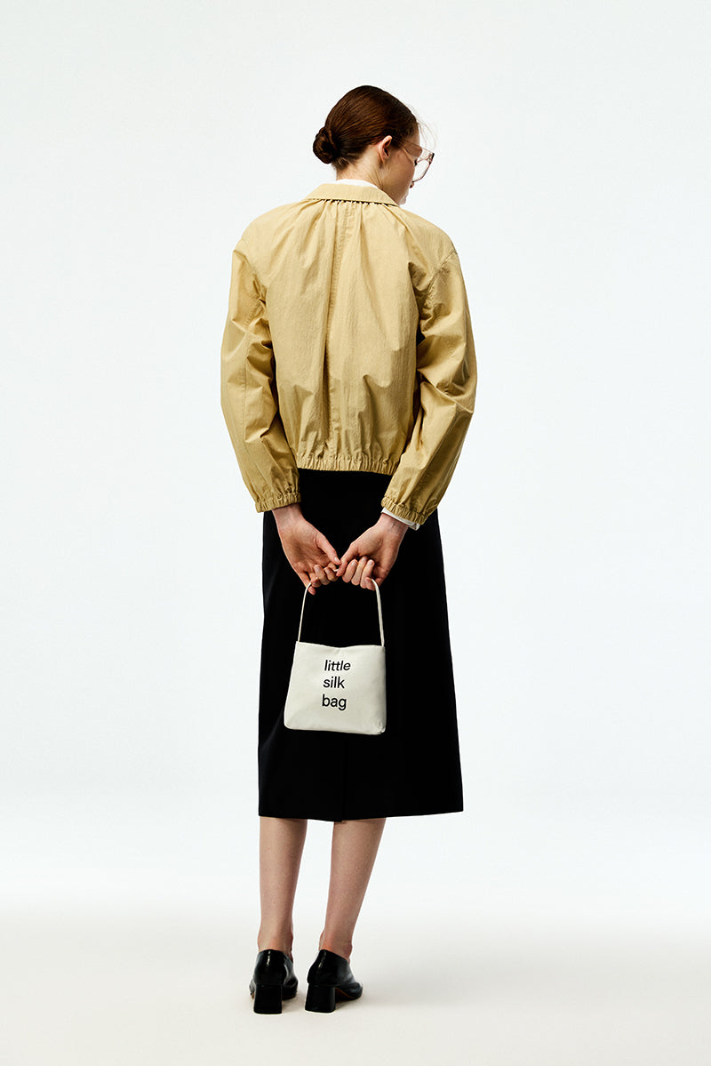 Black silk wool midi skirt by Chictopia, shown with a smooth, flowing fabric and a classic midi length.