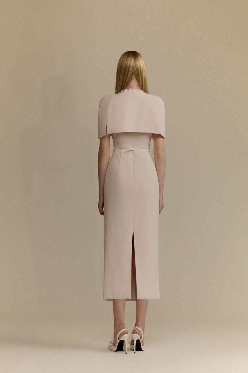 White Plan Mara pink midi dress displayed on a hanger, showcasing its elegant, flowing fabric and stylish design.