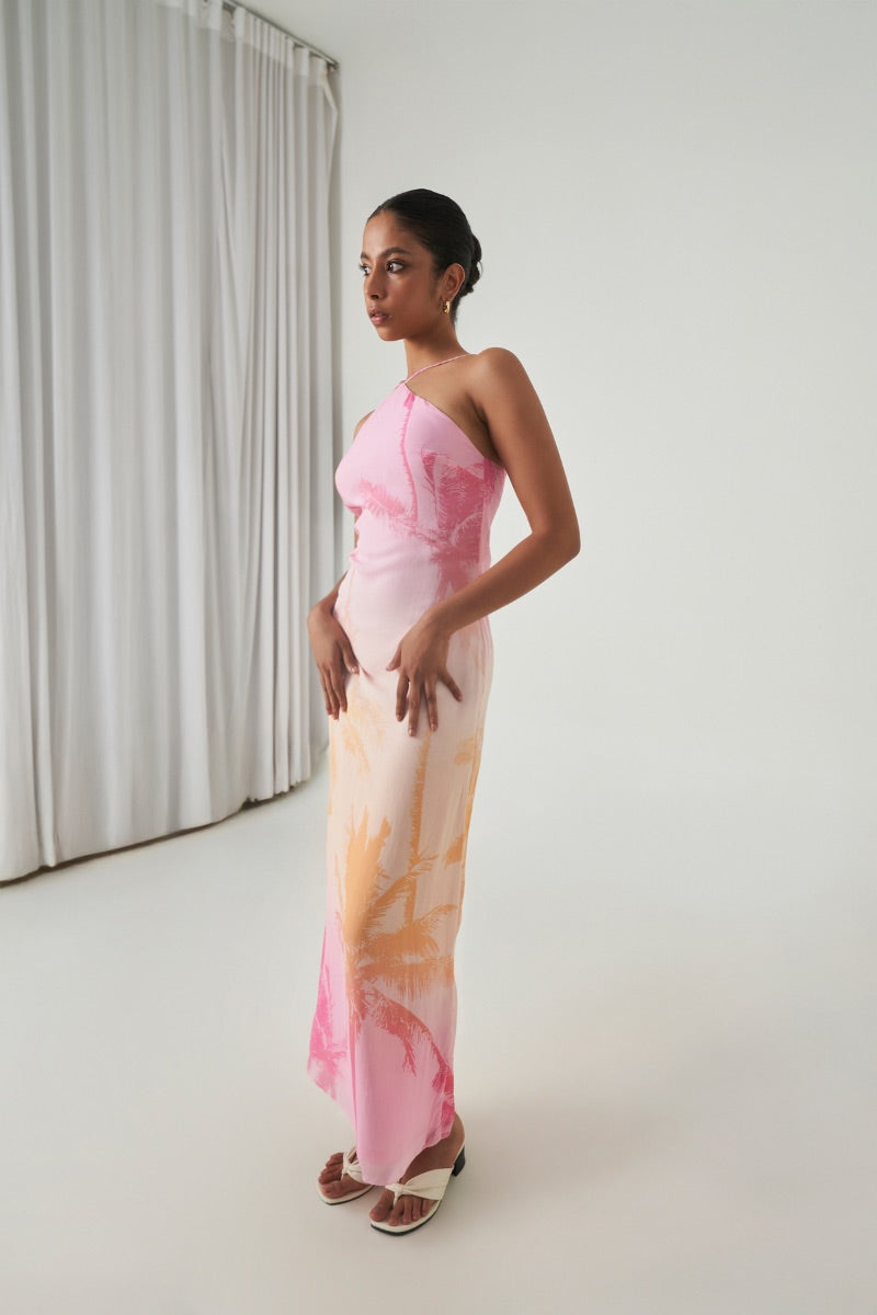 Summer Away Ronda Maxi Dress in Afterglow, flowing fabric with a vibrant sunset-inspired color, styled with thin shoulder straps.