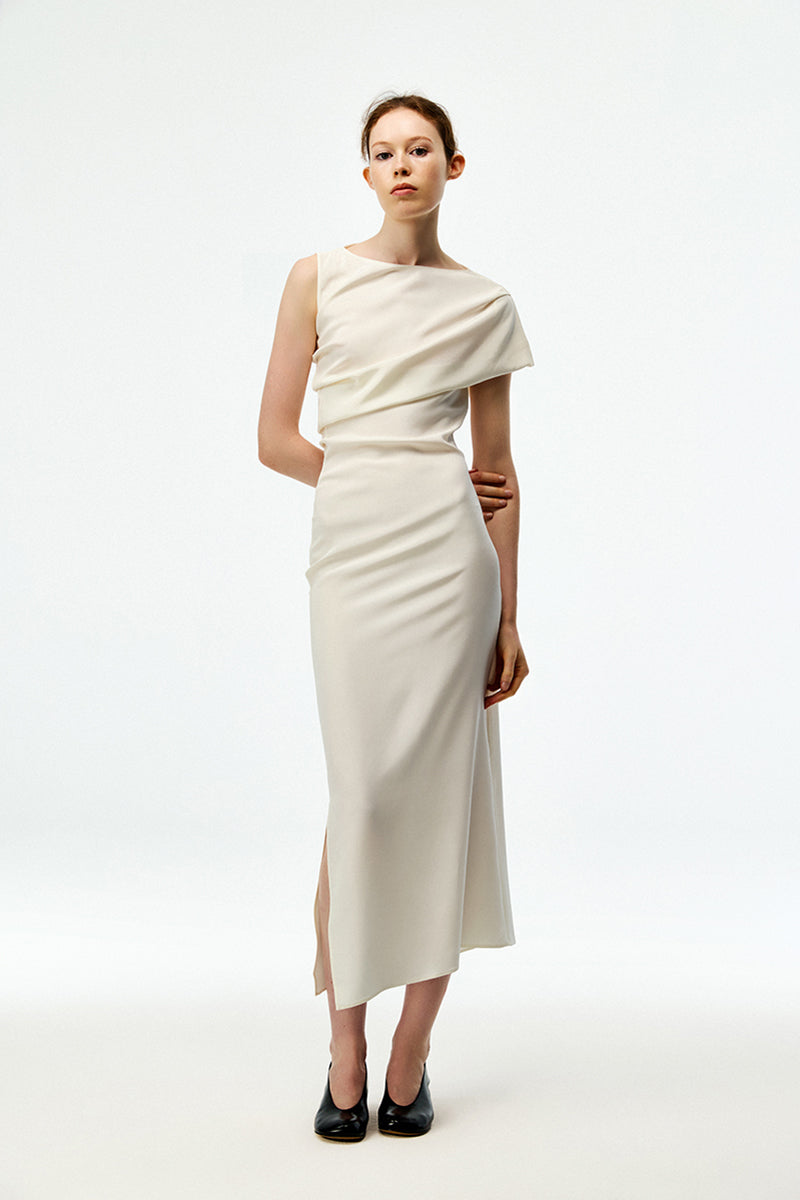 Chictopia ivory crepe maxi dress displayed on a hanger, featuring a flowing silhouette and elegant design.