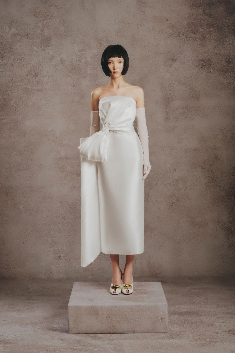 White Plan ivory bow sculpt midi dress featuring a fitted silhouette and elegant bow detail at the waist.