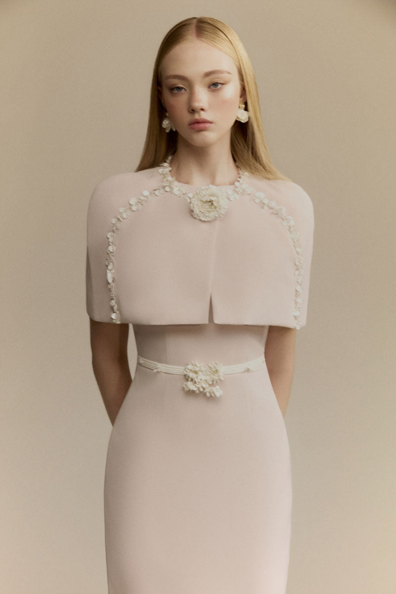 White Plan Mara pink midi dress displayed on a hanger with flowing fabric and elegant design.