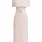 White Plan Mara pink midi dress displayed on a hanger, showcasing its elegant design and vibrant color.