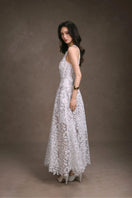 Keira Tong floral lace maxi dress displayed on a hanger with intricate lace details and flowing fabric.