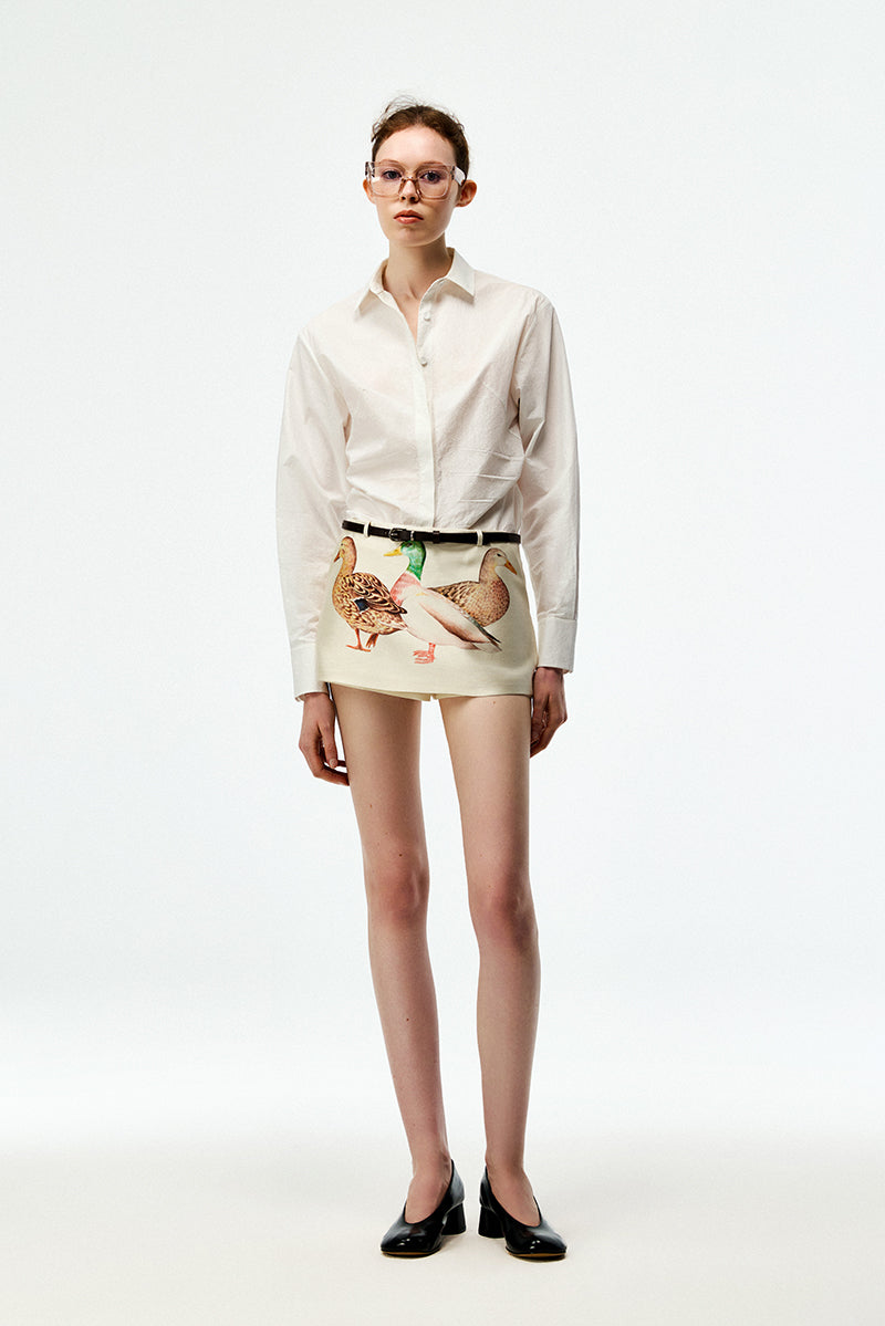 Chictopia ivory Popling shirt displayed on a hanger with a relaxed fit and classic collar, showcasing casual stylish women's clothing.