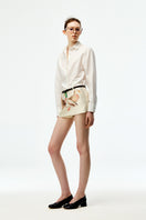 Chictopia ivory poplin shirt featuring a classic collar and button-up front, displayed on a hanger.