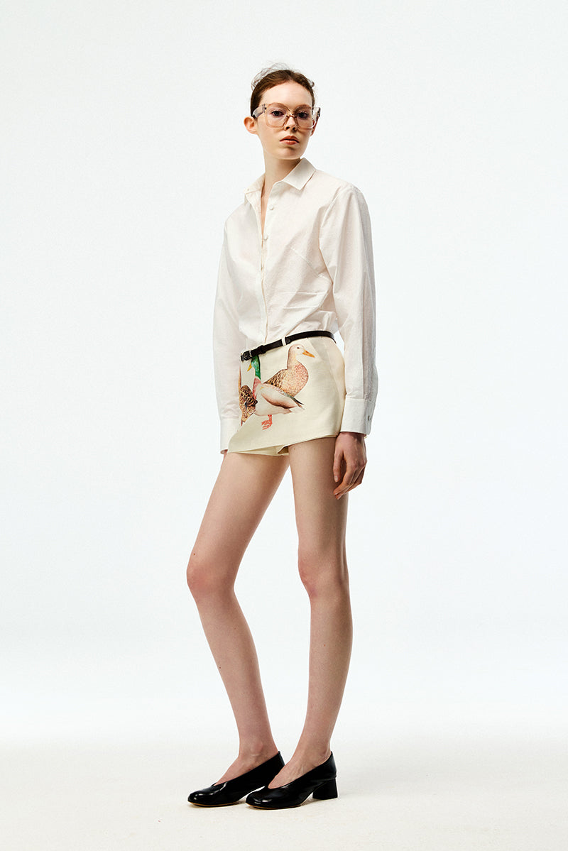 Chictopia ivory poplin shirt featuring a classic collar and button-up front, displayed on a hanger.