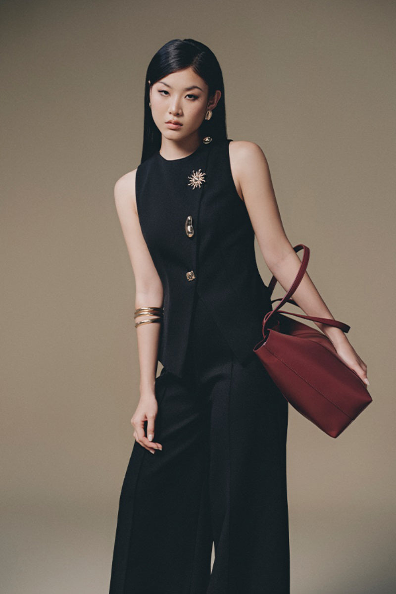 Keira Tong button-up tweed vest with a classic checkered pattern, tailored fit, and stylish collar detail.