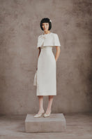 White Plan ivory pearl cape midi dress featuring elegant pearl embellishments and a flowing silhouette.