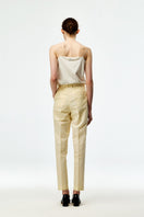 Beige cotton linen pants by Chictopia with a relaxed fit and casual style, shown on a model in the image.