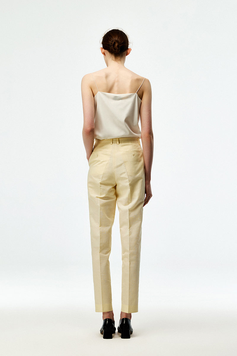 Beige cotton linen pants by Chictopia with a relaxed fit and casual style, shown on a model in the image.