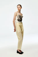 Chictopia beige cotton linen pants with a relaxed fit and tapered leg, displayed on a model against a neutral background.