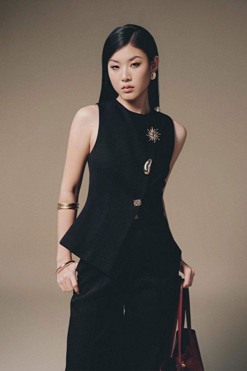Keira Tong button-up tweed vest featuring a classic collar and front buttons, styled with a textured tweed fabric.