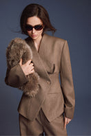 Keira Tong folded blazer, stylish tailored blazer in neutral fabric, displayed folded on a clean surface.