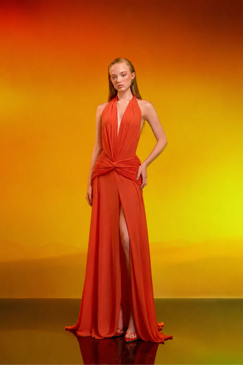 Elegant draped chiffon gown by CEM featuring flowing fabric and a sophisticated design, perfect for formal occasions.