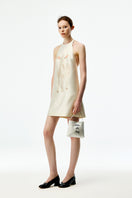 Ivory silk wool mini dress by Chictopia, featuring a stylish, elegant design perfect for casual or semi-formal occasions.