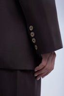 Relaxed single-breasted blazer by Dāl the Label, shown in a neutral color, tailored fit with lapel collar and front button closure.