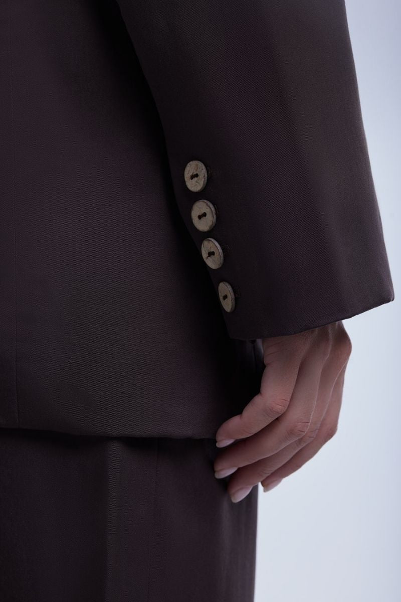 Relaxed single-breasted blazer by Dāl the Label, shown in a neutral color, tailored fit with lapel collar and front button closure.