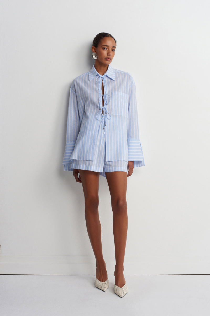 Blue striped Sicilia linen shirt by Acaria Studio, featuring a classic fit and lightweight, breathable fabric for stylish comfort.