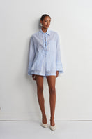 Blue striped Sicilia linen shirt by Acaria Studio, featuring a relaxed fit and lightweight fabric for warm-weather wear.