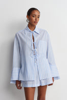 Blue striped Sicilia linen shirt by Acaria Studio, featuring a lightweight, relaxed fit with button-front and collar detail.