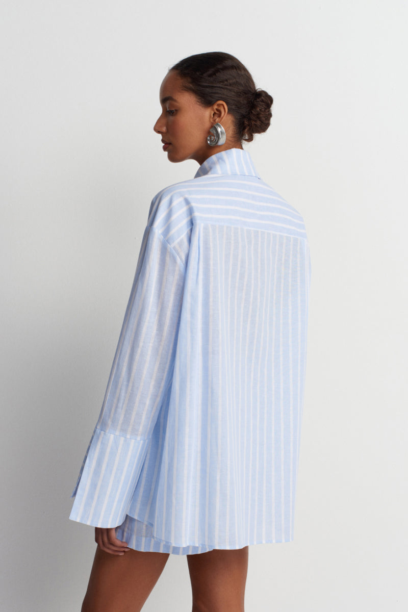 Blue striped Sicilia linen shirt by Acaria Studio, featuring a relaxed fit and button-down collar, perfect for casual wear.