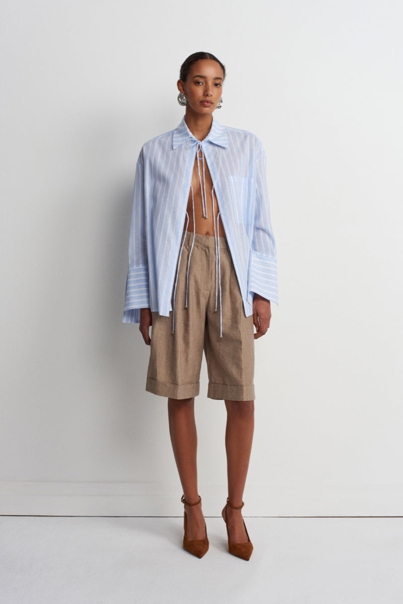 Blue striped Sicilia linen shirt by Acaria Studio, featuring a relaxed fit and lightweight fabric for casual wear.