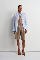 Blue striped Sicilia linen shirt by Acaria Studio, featuring a relaxed fit and lightweight fabric for casual wear.