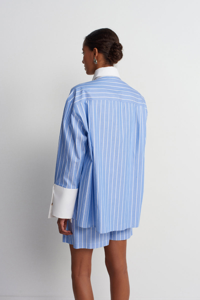 Blue Soulmate shirt by Acaria Studio, laid flat to showcase its fabric and design details.