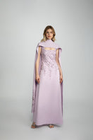 Raishma Lacey gown featuring intricate lace details and a flowing silhouette, displayed on a model.