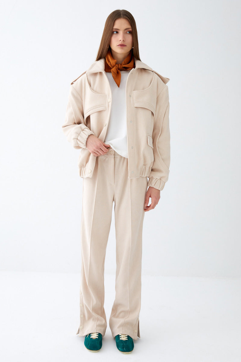 Cream ColoReve soft cave biker jacket displayed on a hanger, featuring a relaxed fit and textured fabric.