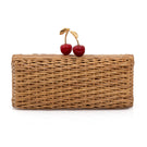 Hand-woven cherry rattan clutch bag by Waiwai Rio, showcasing intricate craftsmanship and natural woven texture.