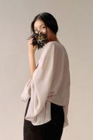 Black LeCia trumpet midi skirt shown on a model, featuring a fitted waist and flared hem for a stylish, feminine look.