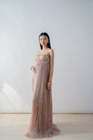 Elegant champagne-colored pleated bustier column maxi dress by DOC BAN, featuring a fitted bodice and flowing skirt.