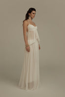 Poem Halcyon white maxi dress displayed on a hanger, showcasing its flowing fabric and elegant design.