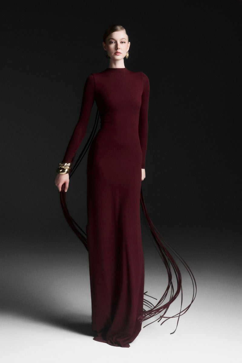 Red Maison Des Copains Avielle draped floor-length maxi dress displayed on a model. Elegant, flowing evening gown.