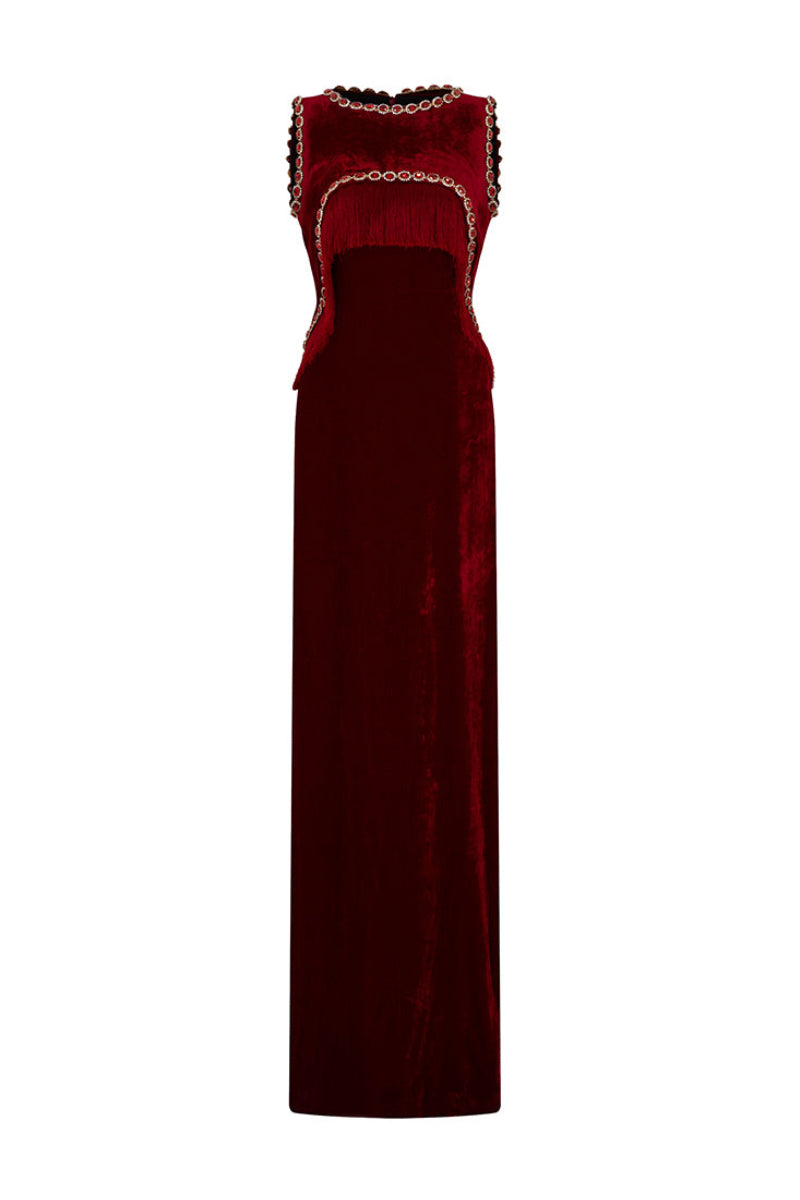 Red Valenciani gown with shoulder cutouts, elegant cape dress design, flowing fabric and stylish silhouette.