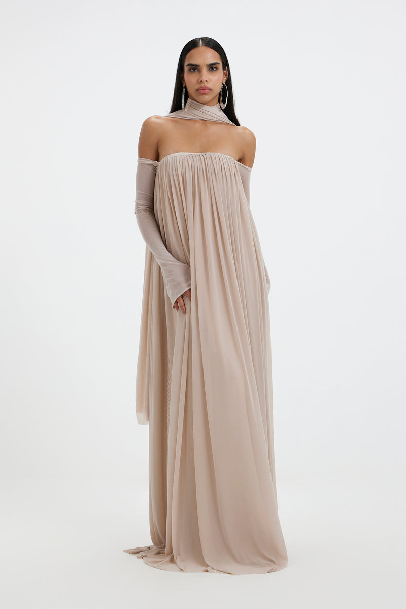 Deme By Gabriella BECKI MAXI DRESS in flowy fabric with a fitted waist and elegant design, shown on a model.
