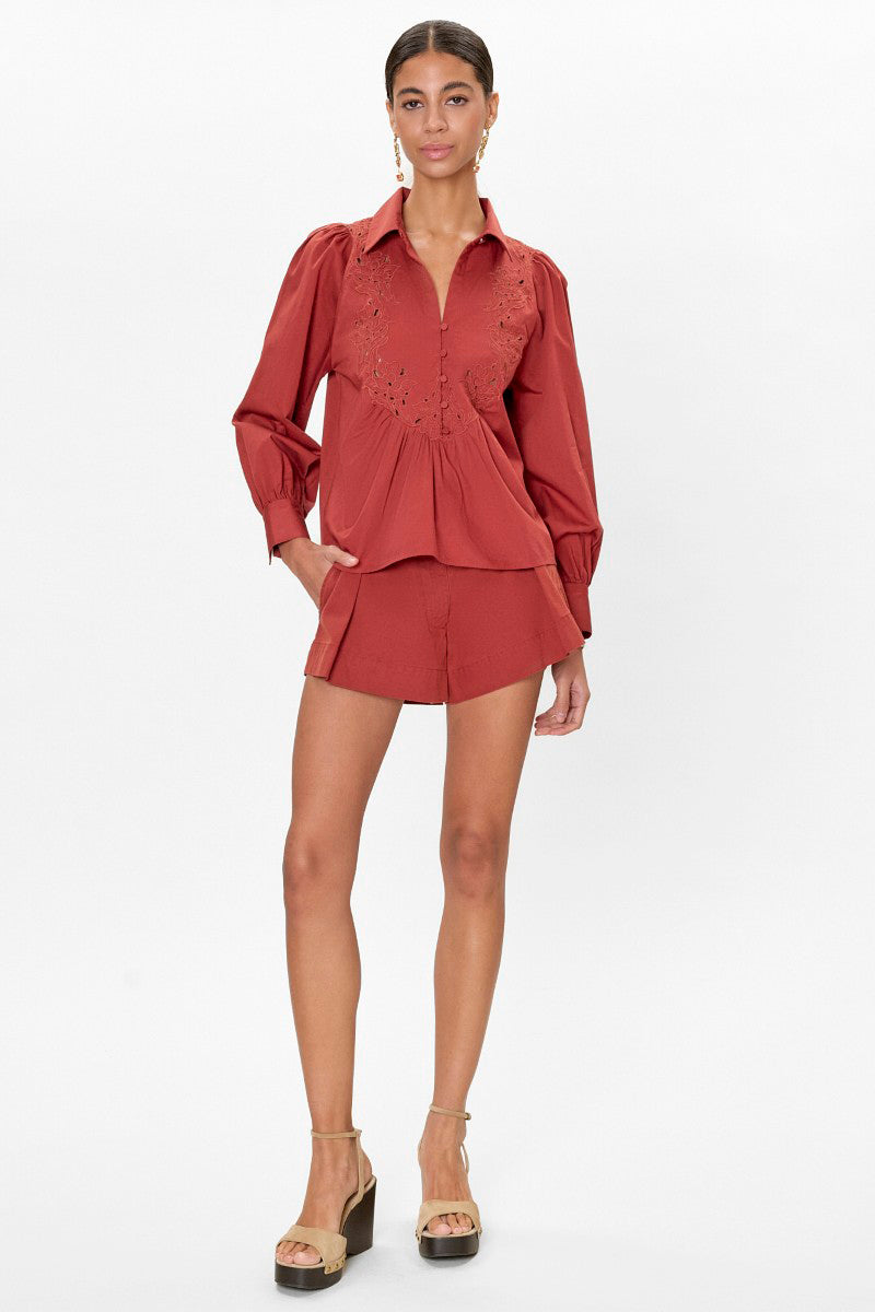 Rebecca Taylor Rachelle pop-over blouse in burnt sienna, featuring a relaxed fit and soft fabric, displayed on a hanger.