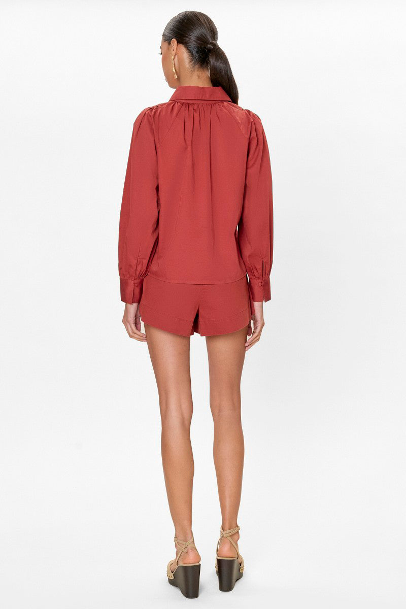 Rebecca Taylor Rachelle pop-over blouse in burnt sienna, featuring a relaxed fit and lightweight fabric, displayed on a hanger.