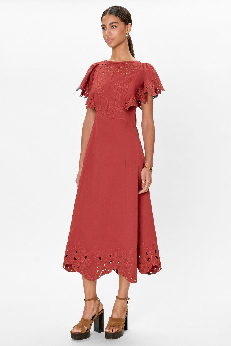 Rebecca Taylor Rachelle midi dress in burnt sienna, featuring a flowy fabric and elegant design, displayed on a hanger.