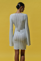Baobab Lion Dress in Crystal Blue mini dress featuring a fitted silhouette and elegant design, showcased on a hanger.
