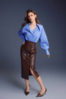 Brown leather sculpted midi skirt by Keira Tong, featuring a fitted silhouette and detailed craftsmanship.