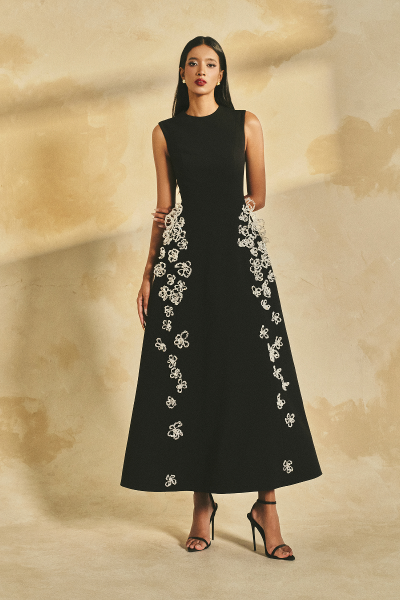 L'SCARLETT sleeveless poly crepe midi flared gown with a fitted bodice and flowing skirt, displayed on a mannequin.