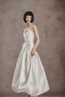 White Plan ivory bloom ball gown featuring a flowing skirt and elegant design, perfect for formal occasions.