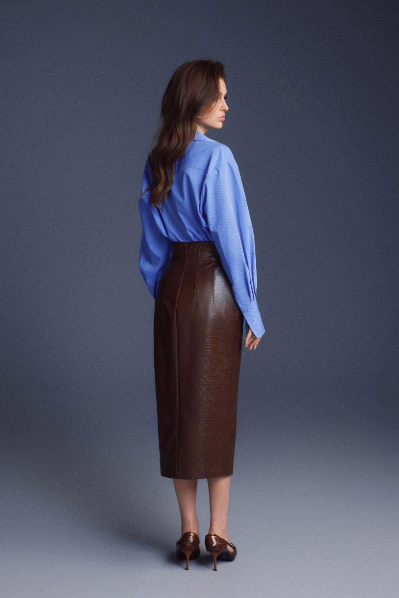 Brown leather sculpted midi skirt by Keira Tong, showcasing a fitted waist and smooth textured fabric.