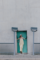 Elegant cream Butter Muse gown by TONYY featuring flowing fabric and intricate design, displayed on a dress form.