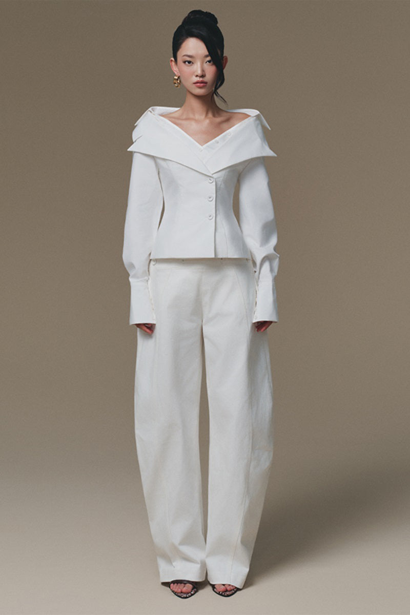 White Selena shirt by Keira Tong, casual button-up shirt with collar and long sleeves, displayed on a hanger.